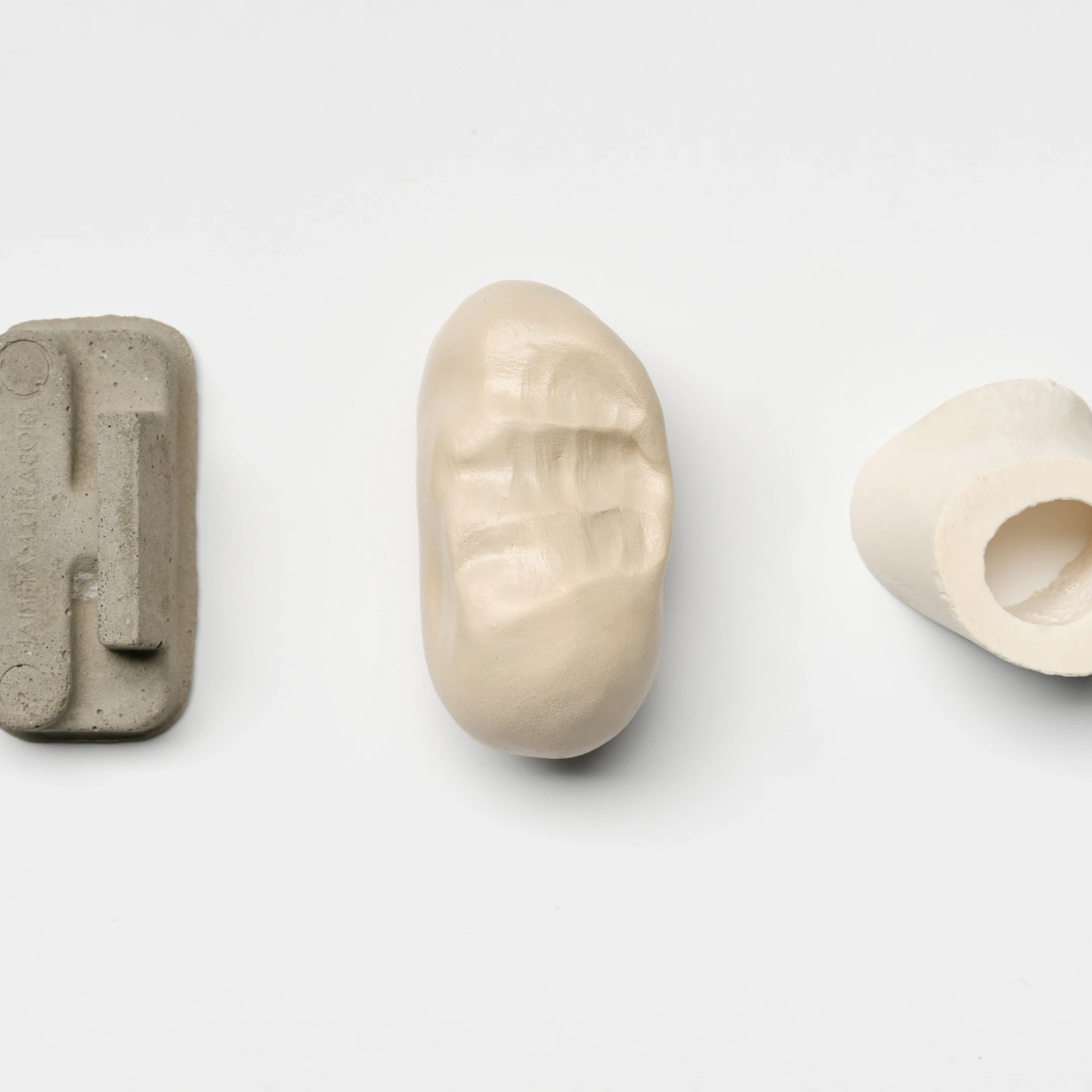 *The building body II*, 2024, Concrete casts, unfired clay sculptures, lacquered, and pieces of bone. 
Photo: Tobias Hübel